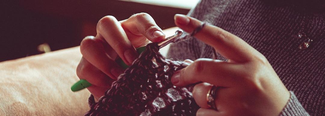 close-up of a woman's hands as she crochets