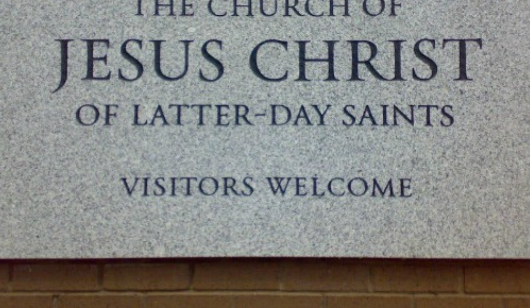 "Visitors Welcome" on a sign on a Church building